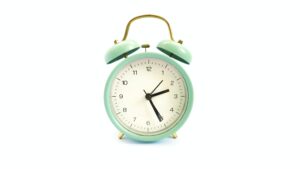 how long before you can see after lasik?; a seafoam green analog clock with a gold handle reading 2:25 on a white background